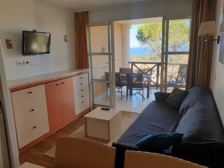 Le salon du T2 d'Agay et la baie vitrée qui ouvre sur la terrasse et la mer